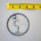 Wire art showing a silver tree with twisted roots and branches against a tape measure to show 3inch size